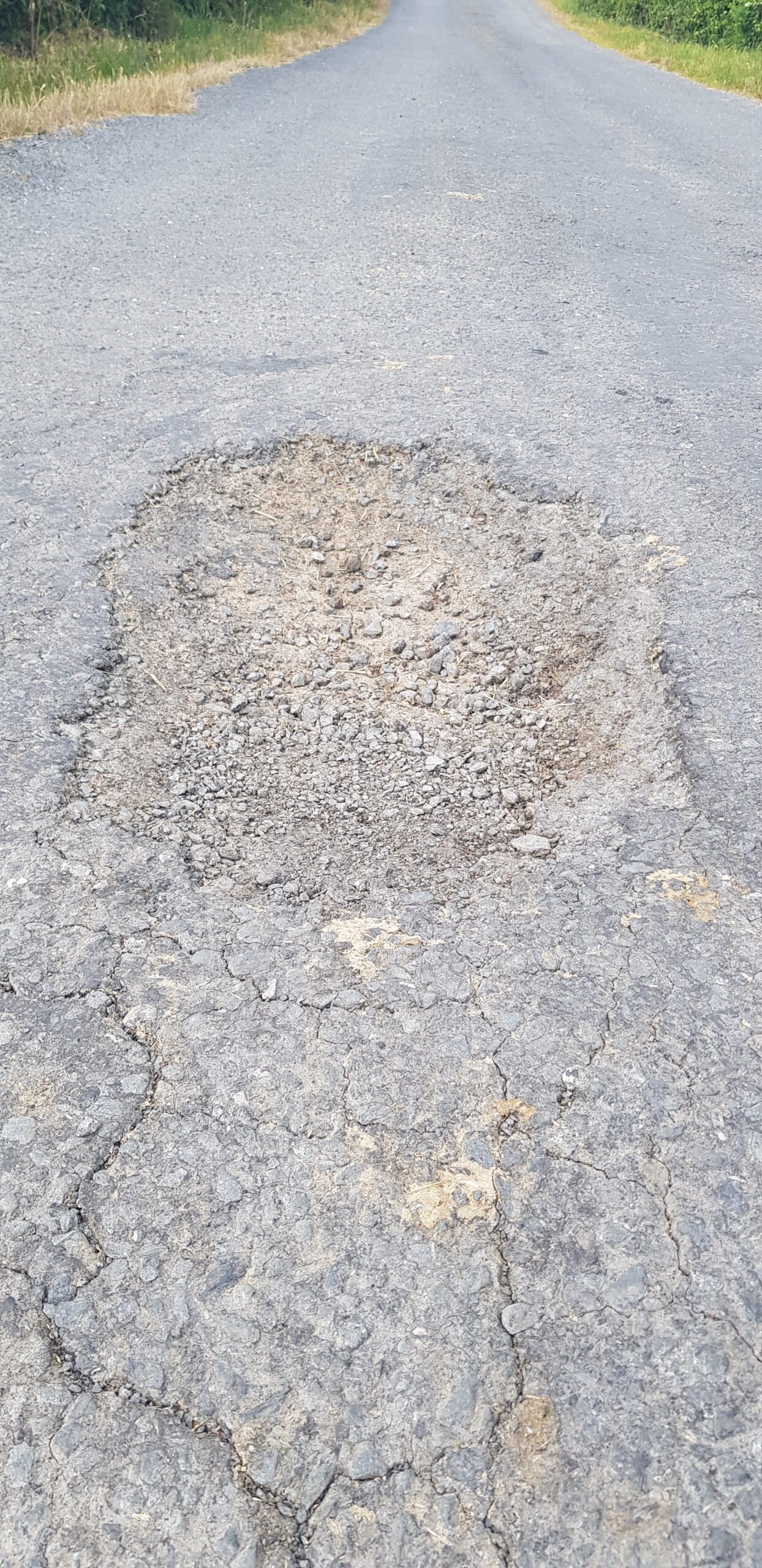 Buraco no pavimento de uma estrada rural, em imagem ilustrativa feita na Irlanda.